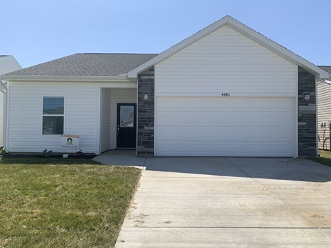 a white house with a sidewalk in front of it